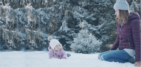 Mother bonding with her child out in the snow