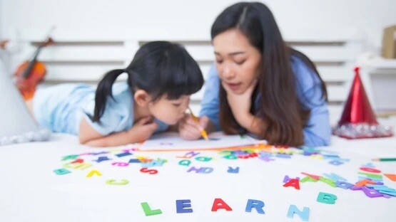 Mother and Child playing with letters