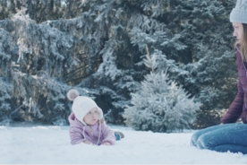 Mother bonding with her child out in the snow