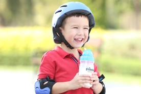 Red shirt kid holding Friso Gold formula milk