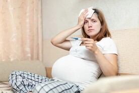 pregnant-woman-with-thermometer-living-room (1).jpg