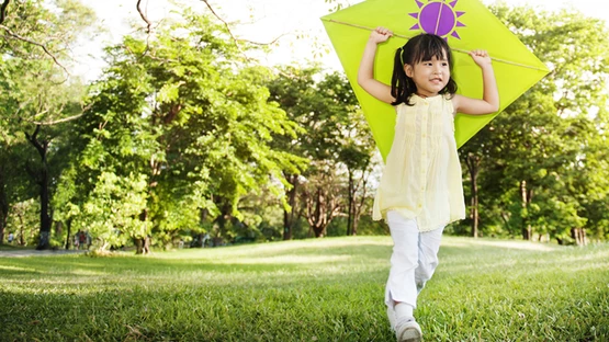 Girl holding a kite outdoor