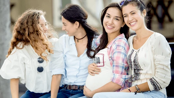 Pregnant woman hanging out with her friends