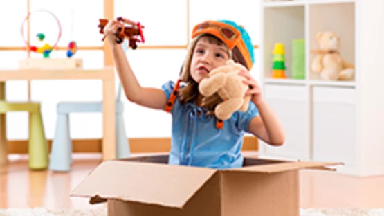 A young child exploring imagination with toys