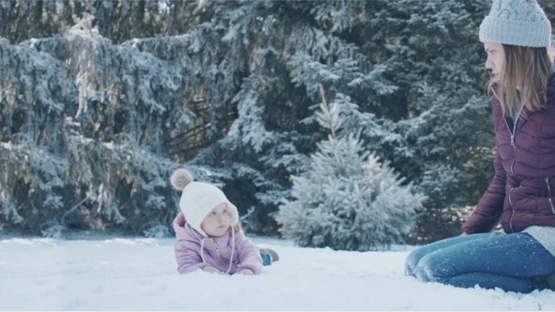 Mother bonding with her child out in the snow