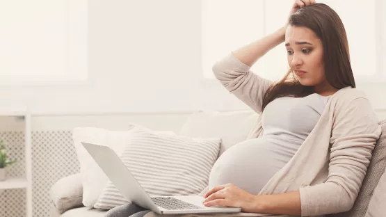 Pregnant woman searching tips on choosing confinement centres