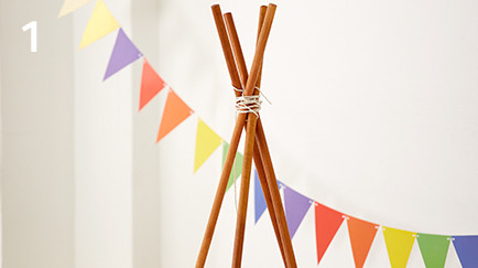 Wooden poles tied up together resembling the frame of a teepee