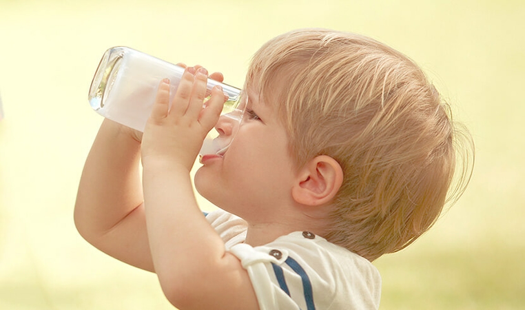 Kid drinking a glass of Friso® Gold Step 3 formula milk